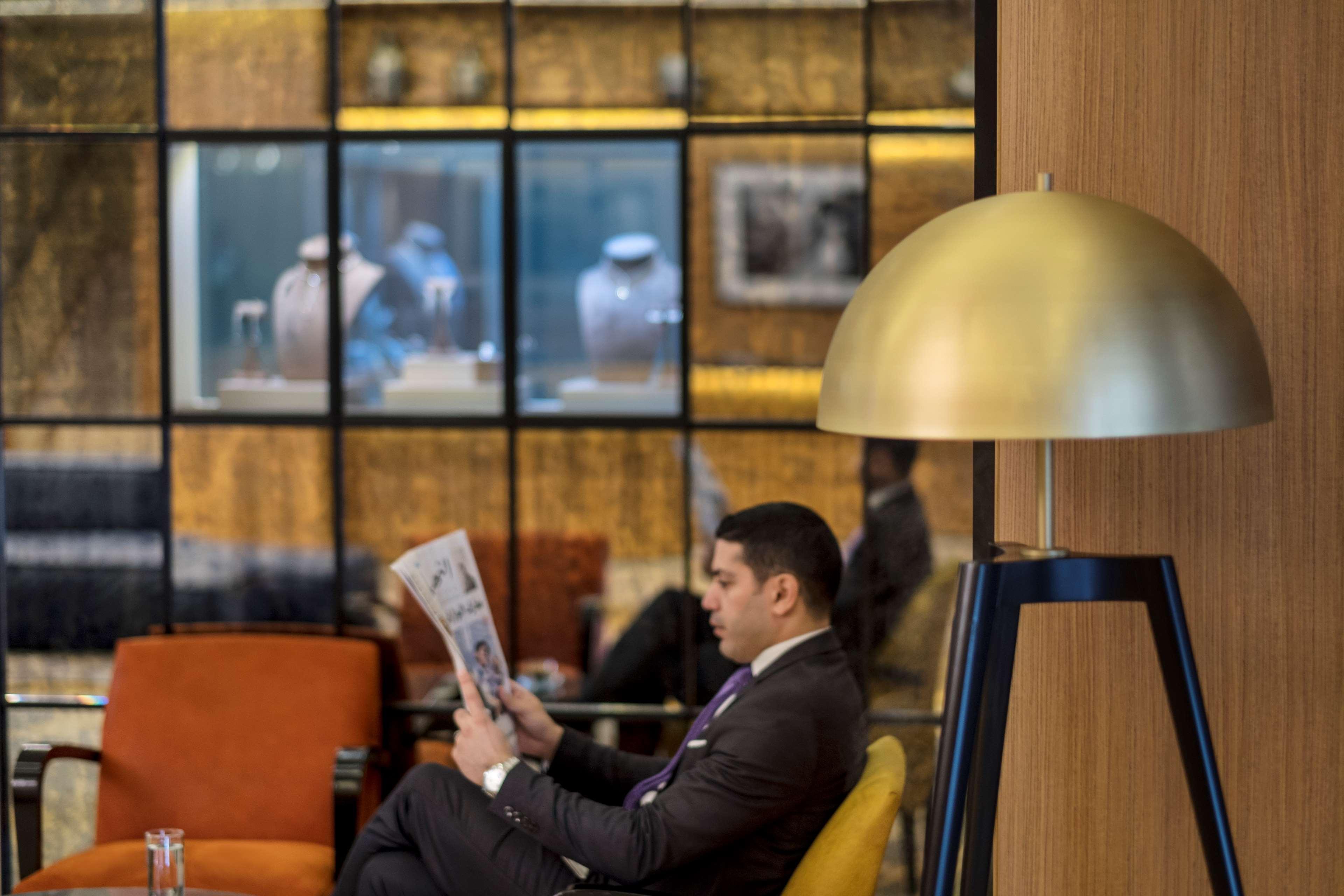 Radisson Blu Hotel, Beirut Verdun Екстер'єр фото A passenger reading a newspaper at the lounge